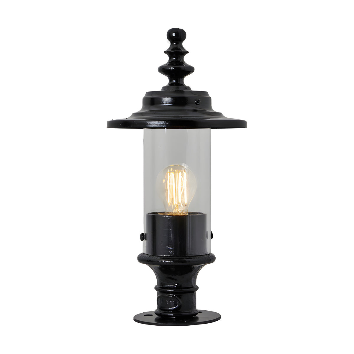 Small Georgian cast iron pillar light in black with clear cylindrical glass shade, ornate finial top and pier cap base, shown lit against a plain white background.