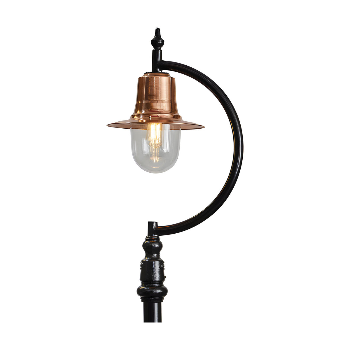 Vintage cast iron lamp post with black gooseneck curve, copper teardrop shade, clear glass dome and lit bulb, ornate base detail, on a plain white background.