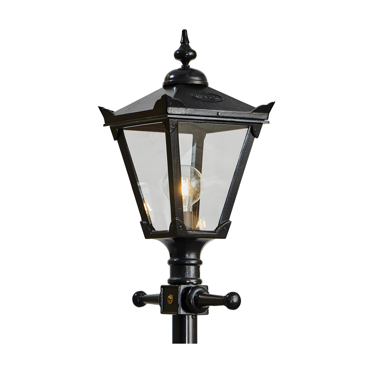 Close-up of the Victorian Manor cast iron lamp post's lantern head in black, with a pointed finial, sloped roof, clear glass panels and visible bulb, on a plain white background.