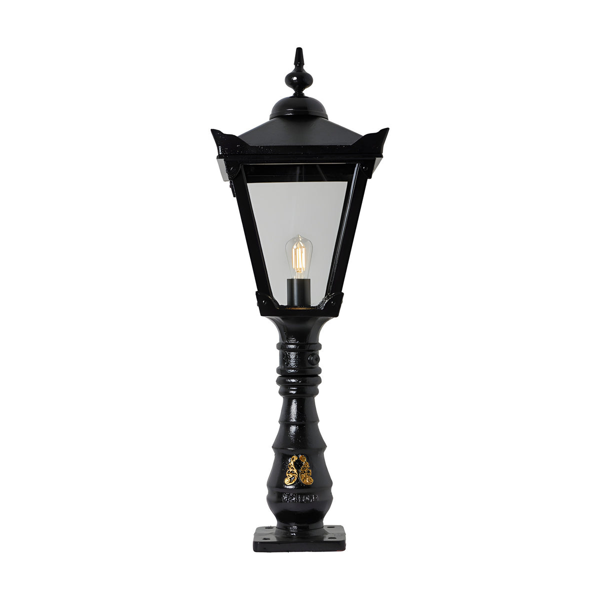 Black cast iron pedestal post light with Victorian Manor lantern design, glass panels, ornate finial, slim column, and base plate, shown on a white background.