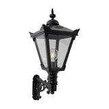 Victorian Manor black wall lantern with clear glass panels and finial top, mounted on a decorative scroll bracket, shown against a plain white background.