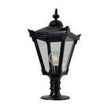 Victorian Manor cast iron pillar light in black with a slim traditional lantern head, clear glass panels, decorative finial, and pedestal base, shown on a plain white background.