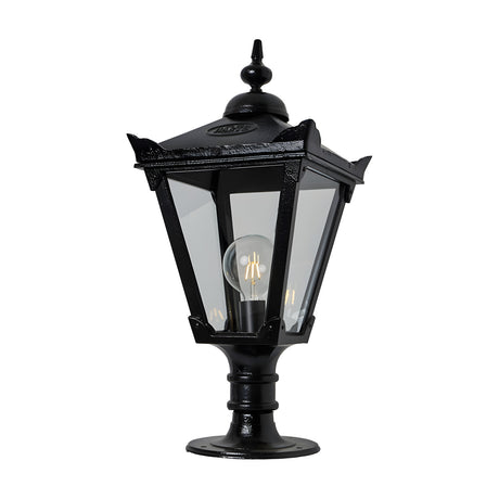 Victorian Manor cast iron pillar light in black with a slim traditional lantern head, clear glass panels, decorative finial, and pedestal base, shown on a plain white background.