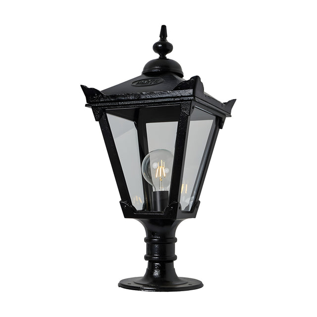 Victorian Manor cast iron pillar light in black with a slim traditional lantern head, clear glass panels, decorative finial, and pedestal base, shown on a plain white background.