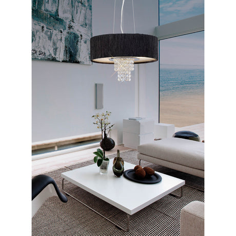 Nerissa 4 Light E14 Chandelier 35cm in polished chrome with black drum shade and clear crystal drops, shown hanging above a coffee table in a living room with sea view.