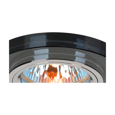 Close-up of the Crystal Shallow Downlight Rim in black, 90mm cut crystal facing edge over a 62mm cut-out, chrome inner ring, with lit bulb visible inside, on a plain white background.