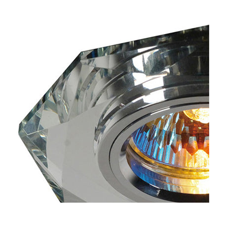 Close-up of the Crystal Downlight Rim, a clear octagonal faceted crystal trim with 10cm face and 62mm cut-out, chrome inner ring, shown lit with a bulb visible.