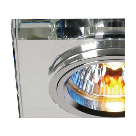 Close-up of the Crystal Shallow Downlight Rim, a square clear-cut crystal face with chrome inner ring around a lit GU10 bulb, 90mm outer with 62mm cut-out.