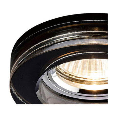 Close-up of the Crystal Round Downlight Rim in black, showing its faceted crystal edge and chrome downlight fitting with GU10 bulb illuminated, on a white background.