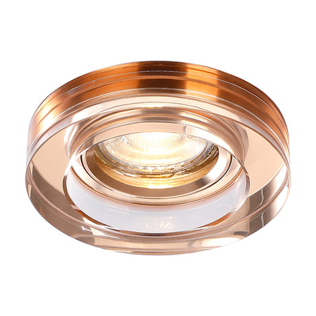 Crystal round downlight rim in rose gold with a 62mm cut-out and 90mm face, shown lit with a warm white bulb against a plain white background.