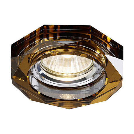 Octagonal crystal downlight rim in bronze with a deep faceted profile, 90mm diameter for a 62mm cut-out, chrome inner ring with lamp lit, on a white background.