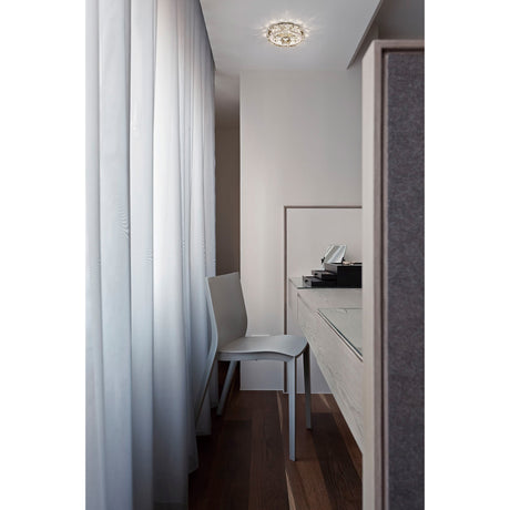 Galaxy Round Downlight in polished chrome with clear crystal detail, recessed into a bedroom ceiling above a dressing table and mirror.