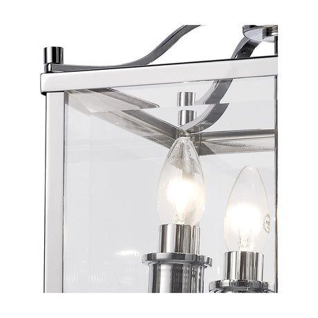 Close-up of the Aston 4 Light Lantern Semi Flush Ceiling Light in polished chrome, showing clear glass panels, candle lamps, and chrome fixings against a white background.
