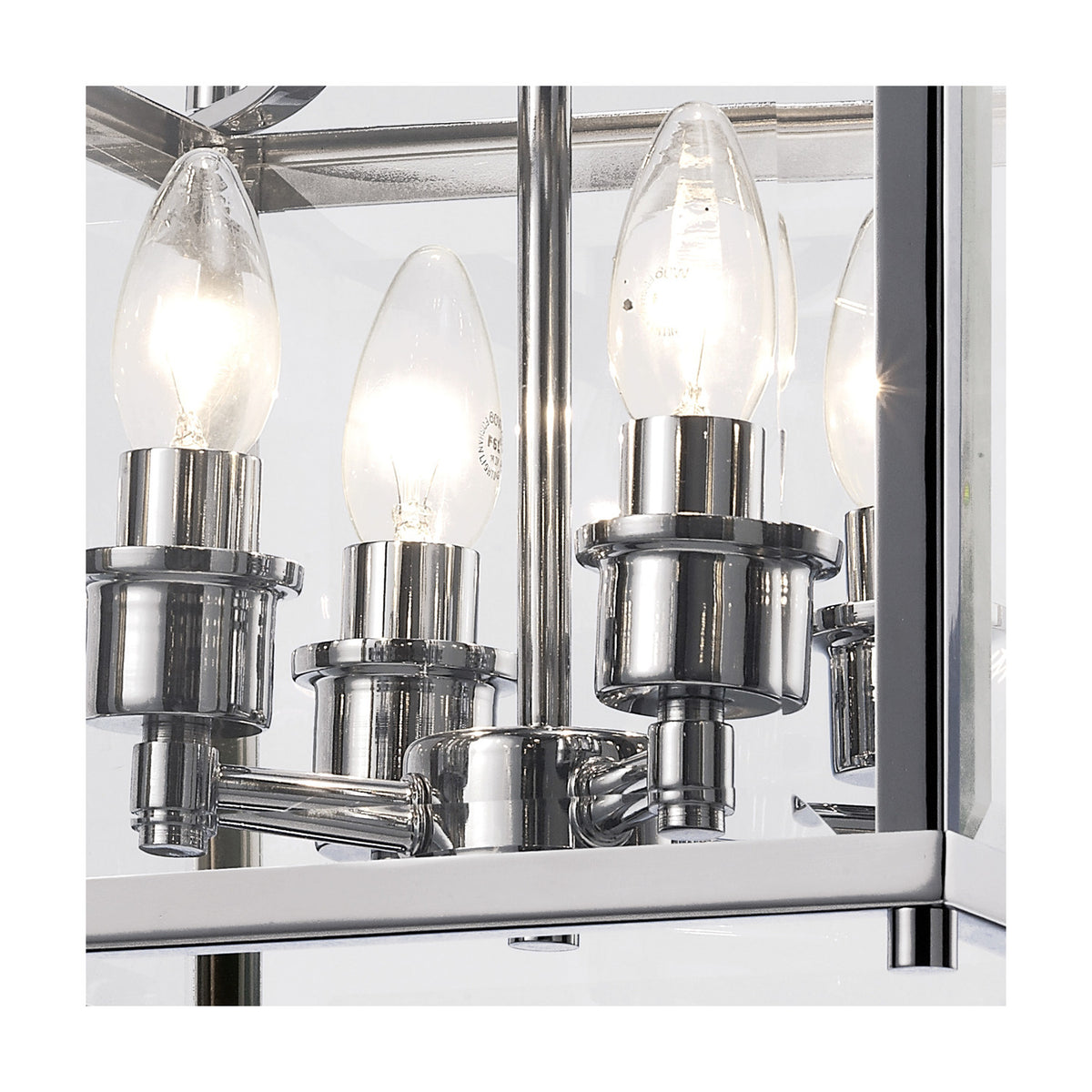 Close-up of the Aston 4 Light Lantern Semi Flush Ceiling Light, showing four lit candle bulbs on polished chrome fittings within a clear glass frame.