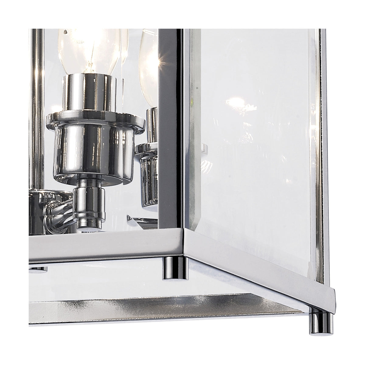 Close-up of the Aston 4 Light Lantern Semi Flush Ceiling Light in polished chrome, showing clear glass panels and candle bulb fittings on a white background.
