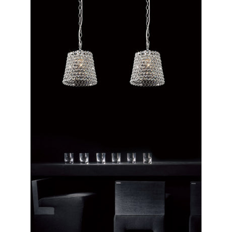 Two Kudo 21cm crystal lamp shades in polished chrome hang above a dining table with glassware, set against a dark room backdrop.