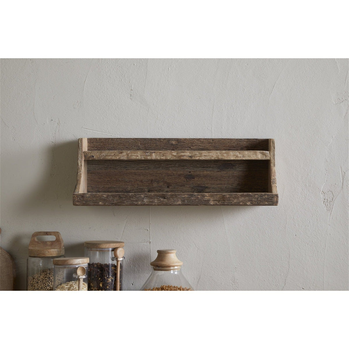 Ibo Reclaimed Wood Wall Shelf in natural finish, a two-tier rustic design with curved side supports, mounted above kitchen jars against a plain wall.