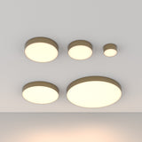 A minimalist ceiling design showcases luxury lighting with five Zon LED Downlight 3000K 12W fixtures in matte gold, flush-mounted in varying sizes on a white ceiling, emitting a soft, warm glow arranged neatly.