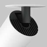 Close-up of the Focus LED Single Recessed Spotlight 12W 3000K - White, featuring a minimalist cylindrical design with a black internal structure. The fixture is mounted via a short black rod, providing energy-efficient lighting against a neutral gray background.