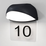 The Gloss Outdoor LED Wall Light - Graphite is a modern wall-mounted lamp with an energy-efficient LED, featuring a clear panel displaying the number 10 in bold black font. It offers a sleek, curved design with a graphite finish and boasts an IP65 protection rating for durability.