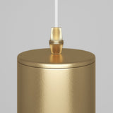 A close-up of the Focus Single Pendant Light in matte gold against a light gray background, featuring a textured finish. A white cord elegantly extends from the top, connecting to a small gold fitting.