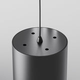 Close-up of the Polar Short Round Pendant Light - Black, featuring five top holes. Suspended by a thin cable, its minimalist and contemporary design adds a modern touch to any space.