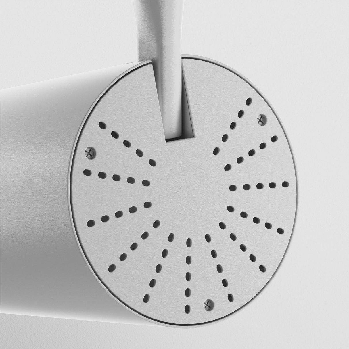 A front-view close-up of a metal watering cans spout shows its round face with evenly spaced holes, illuminated by the Vuoro S LED Single Phase Unity Track Spotlight 15W 4000K in white. Its sleek, modern design and light gray finish add elegance to your garden décor.