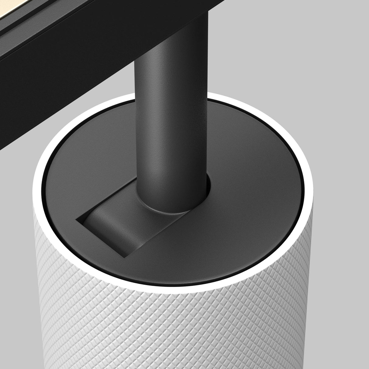 Close-up of the Artisan LED Magnetic Exility Track Spotlight 12W 4000K, featuring a textured cylindrical base in white and a black pole against a gray background. The minimalist design includes an anti-glare filter.