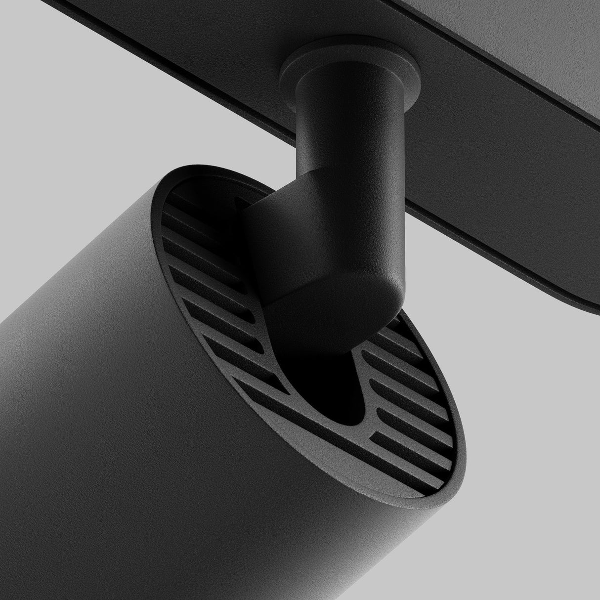 A close-up shows a Focus LED Magnetic Radity Track Spotlight 12W 3000K - Black, with a vented cylindrical design. Its attached to a flat surface by a hinged joint, perfect for modern interiors and accent lighting, set against a plain gray background.
