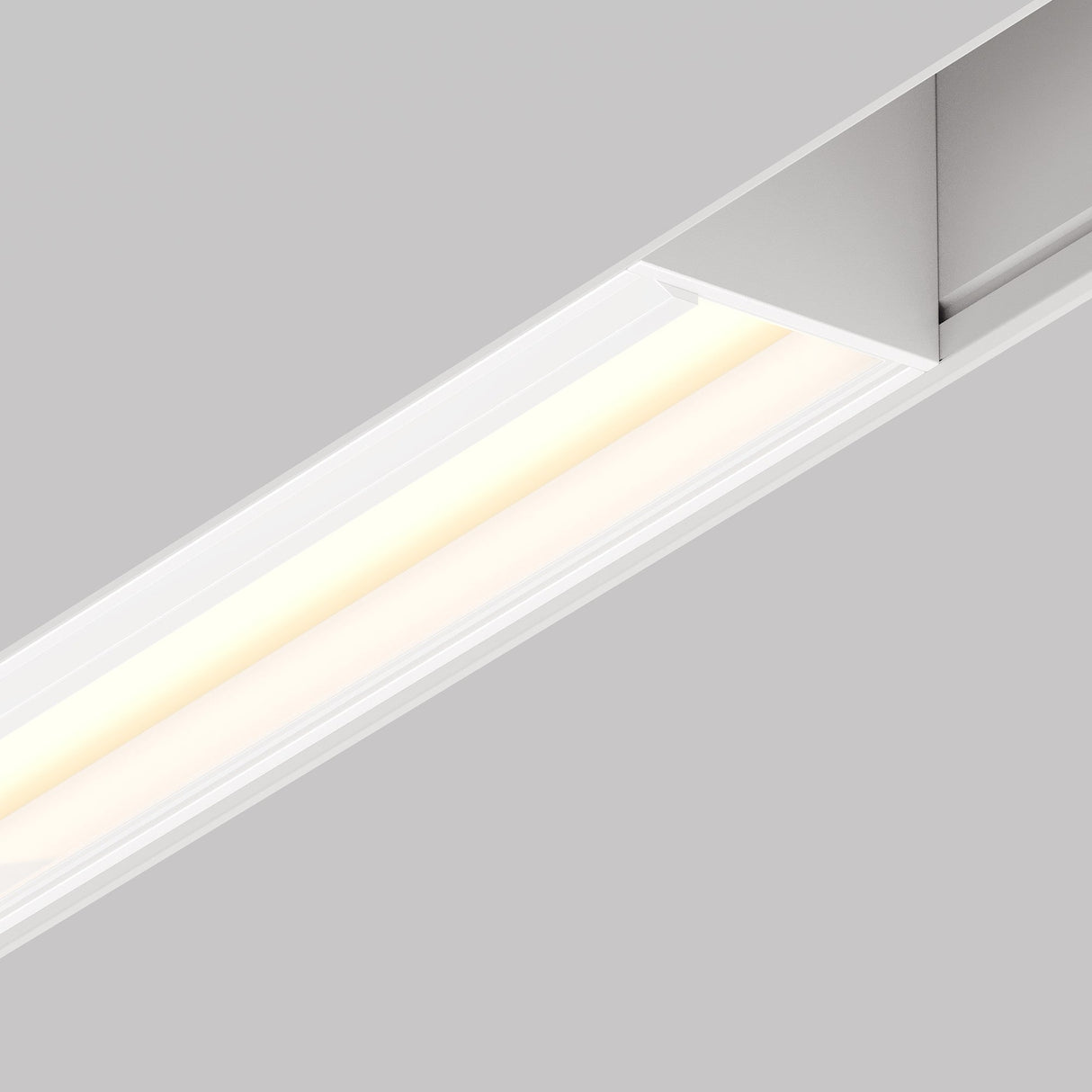 The Parete LED Linear Track Light for Magnetic Exility 12W 3000K in white offers a sleek, modern design with a soft ambient glow. Its minimalist aesthetic seamlessly integrates into any magnetic track system for versatile lighting solutions against a plain gray background.