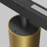 Close-up of the Alfa S LED Magnetic Exility Track Downlight 7W 3000K - Brass featuring a gold cylindrical base with black stem and top, notched design, reflective surface, and matte brass finish for energy-efficient lighting.