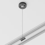 Close-up of the Unity Single Phase Surface-Mounted Track Suspension Cable in black, featuring a round attachment point and cable for supporting track lighting. This system enables seamless mounting of additional fixtures or components. The background is plain white.