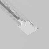 Close-up of the Unity Tracks Power Feed in white, a ceiling-mounted track lighting system. It features a power feed connector and rectangular cover plate with screws. The minimalist, aluminum design contrasts against a light gray background.