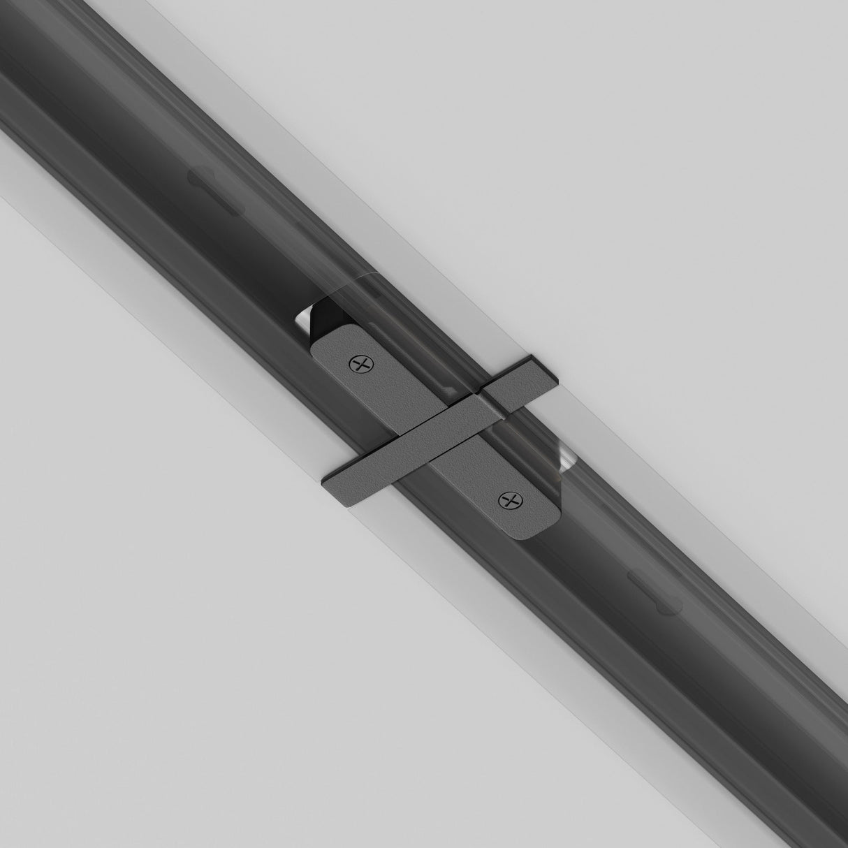 Close-up of the Unity Tracks Recessed Straight Connector in sleek black, featuring a durable aluminium hinge mechanism with a rectangular design and visible screw heads on a gray surface, arranged diagonally across a tubular structure.