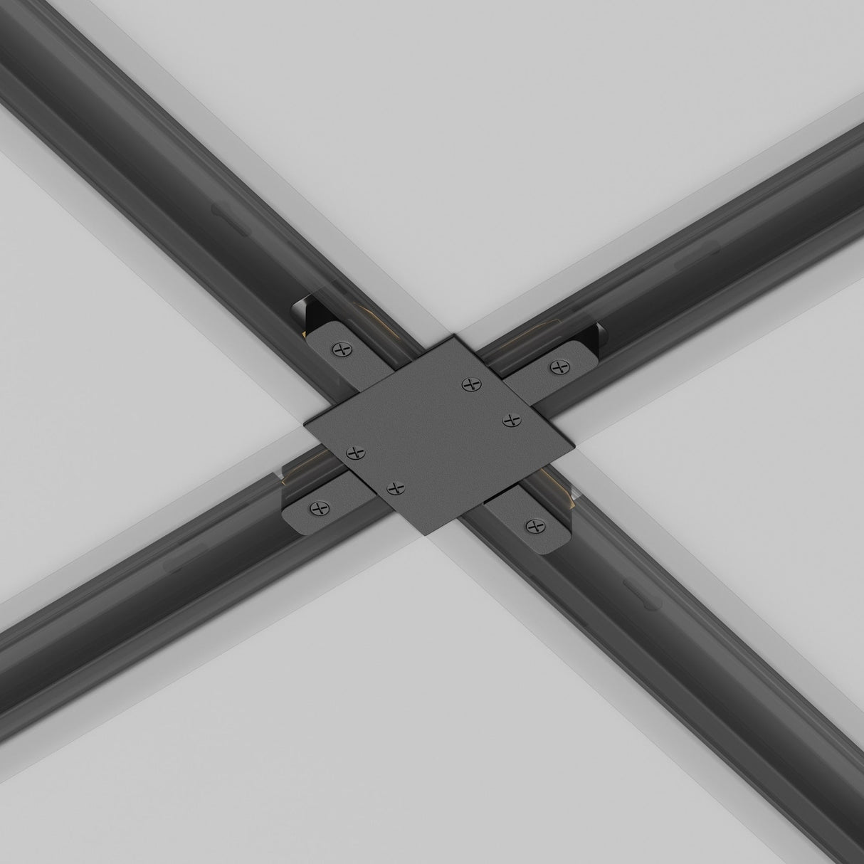 Close-up of the black Unity Tracks Recessed X-Shaped Connector linking four beams at right angles on the ceiling. The dark gray beams converge neatly, secured by screws, creating a symmetrical intersection against the light gray background with seamlessly integrated track lighting.