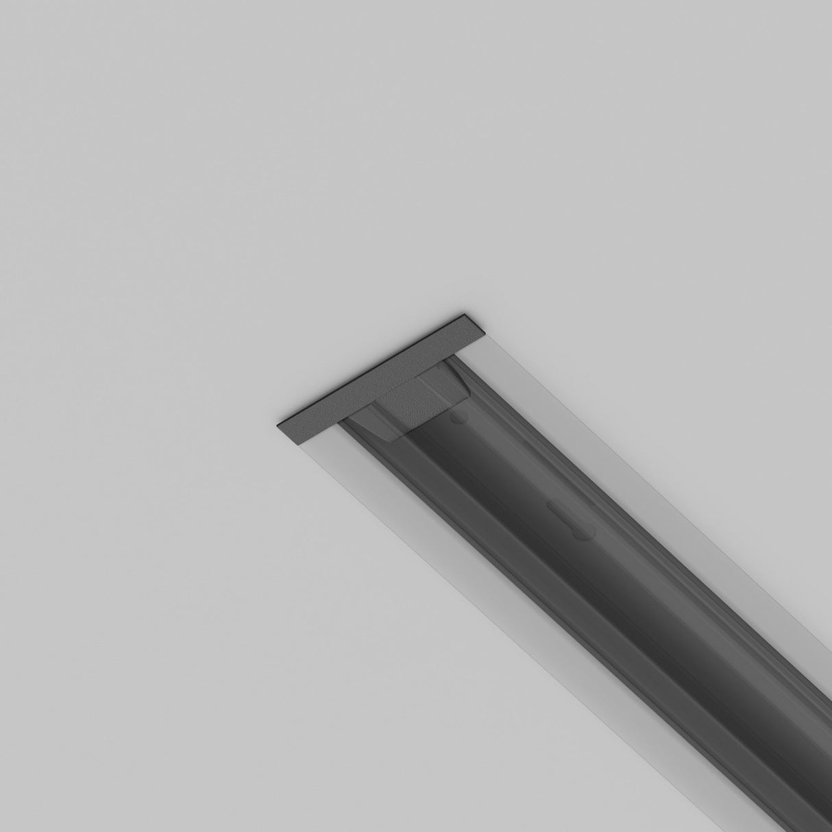 A sleek, black Unity Tracks Single Phase Track End Cap is mounted on a white surface, possibly a ceiling. It appears to be an integrated lighting fixture or panel with a minimalist design, part of a sophisticated single-phase track lighting system.