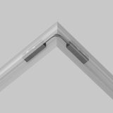 In the corner of a gray room, the Exility Track Flexible Corner Power Connector 15cm - Black joins sleek track lighting sections at a right angle. Its sophisticated and minimalist design seamlessly complements the space.