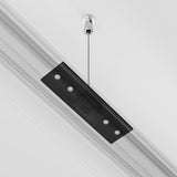 The Exility Magnetic Surface-Mounted Track Suspension Cable in black features a slim, rectangular shade with four circular cut-outs for an industrial-chic vibe, elegantly suspended by a thin metal rod on your white ceiling.