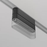 A sleek black and gray rectangular lighting fixture, mounted with a Radity Magnetic Track Short Adaptor - Black, features a transparent casing that shows its inner components, contrasting beautifully with the light-colored ceiling for customizable lighting.