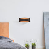 Stylish black Trame LED wall light shown in a modern room setting, perfect for adding subtle illumination.