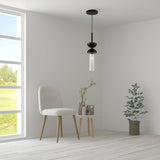Minimalist room with a beige chair and small round table holding flowers. A Kyoto Pendant Light - Black & Black Marble Base hangs above. A large window reveals a green landscape, while a potted plant rests on the floor. Light-colored walls and flooring enhance the customizable lighting options.