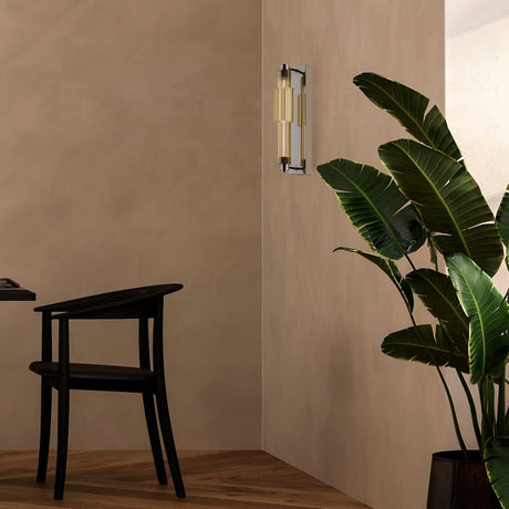 A modern interior includes a black chair and a large potted plant with broad green leaves in the corner, while the Verticale LED Wall Light 3000K 8W - Chrome with Cognac Ribbed Glass emits a soft glow. Light, warm-toned walls and floors create an inviting atmosphere.