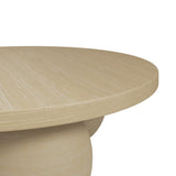 Close-up of the Kenji Calico Coffee Table showing a round concrete top with a woodgrain-textured beige finish and pedestal base, on a plain white background.