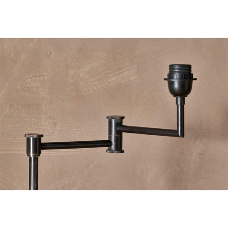 Close-up of the Kara Adjustable Iron Floor Lamp Base in aged bronze, showing the knurled swing-arm pivots and E27 lampholder against a neutral background.