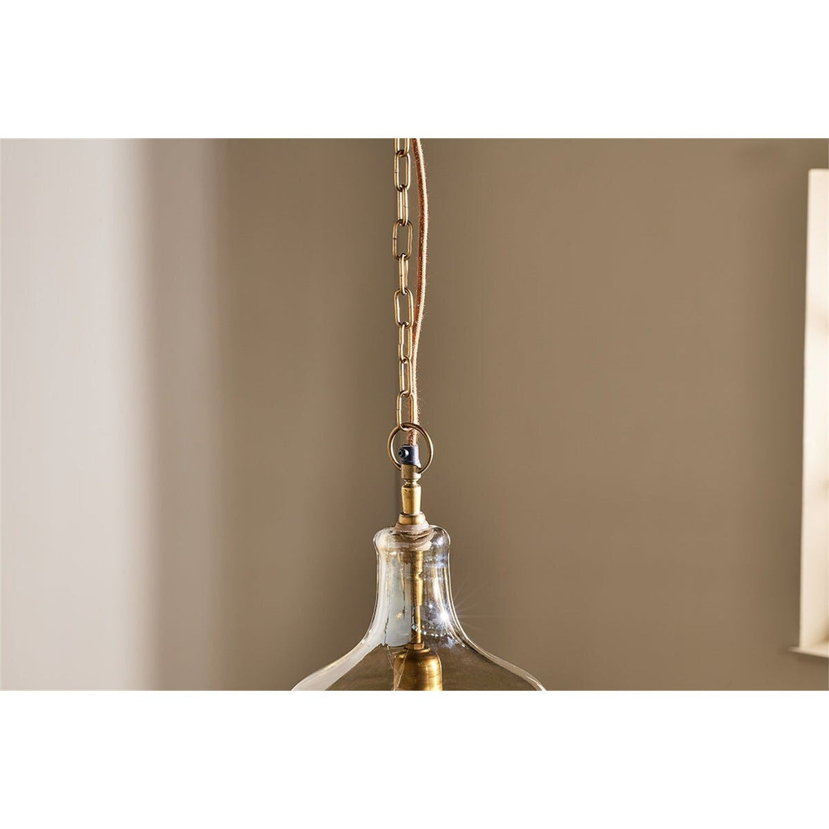 Kalsi Large Recycled Glass Pendant Light in Lustre finish, showing the brass neck collar and chain link against a neutral wall, with the flared glass shade below.