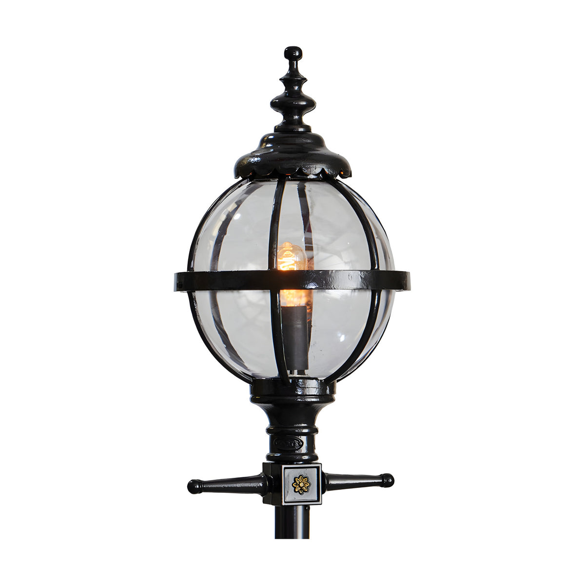 Cast iron globe lantern head in black with clear glass panels and ornate finial top, shown lit on a plain white background, designed to fit a 62mm spigot post.