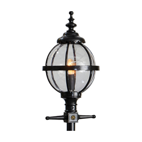 Cast iron globe lantern head in black with clear glass panels and ornate finial top, shown lit on a plain white background, designed to fit a 62mm spigot post.