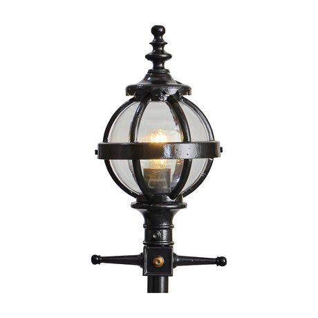 Cast Iron Replacement Globe Lantern head in black with clear glass panels and ornate finial, fitted with a lit bulb on a 44mm spigot mount, shown on a plain white background.