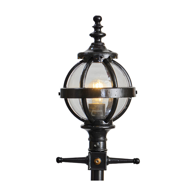 Cast Iron Replacement Globe Lantern head in black with clear glass panels and ornate finial, fitted with a lit bulb on a 44mm spigot mount, shown on a plain white background.
