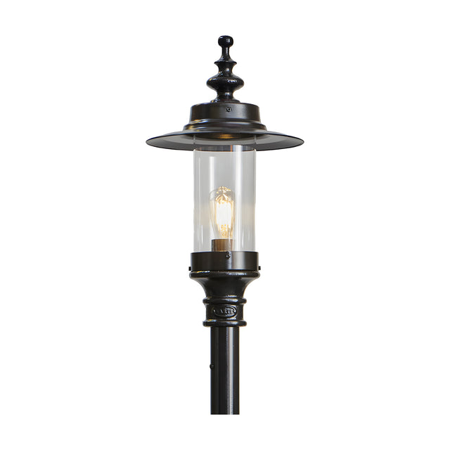 Cast iron Georgian lantern head in black with clear glass cylinder, exposed bulb, and decorative finial cap, shown mounted on a black post against a plain white background.